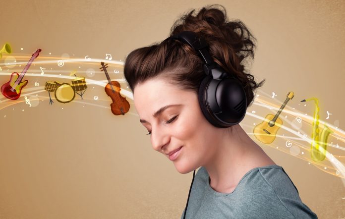 Pretty young woman listening to music, instruments concept
