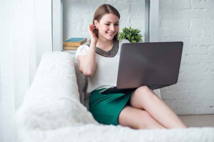 Attractive woman with laptop having break in office
