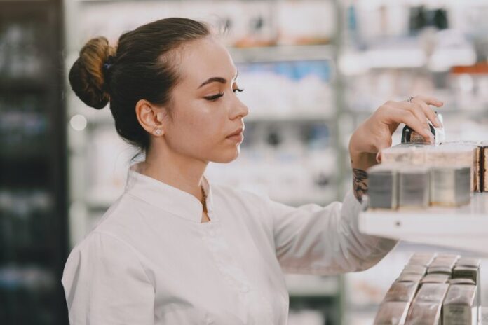 medicine-pharmaceutics-health-care-people-concept-female-pharmacist-taking-medications-from-shelf_1157-42168